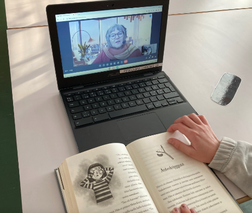 The student is reading at school and reading granny Mirja is located remotely in the library.