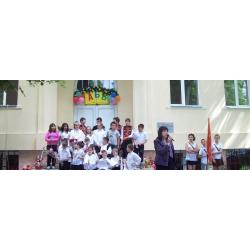 front door of the school with kids and head teacher